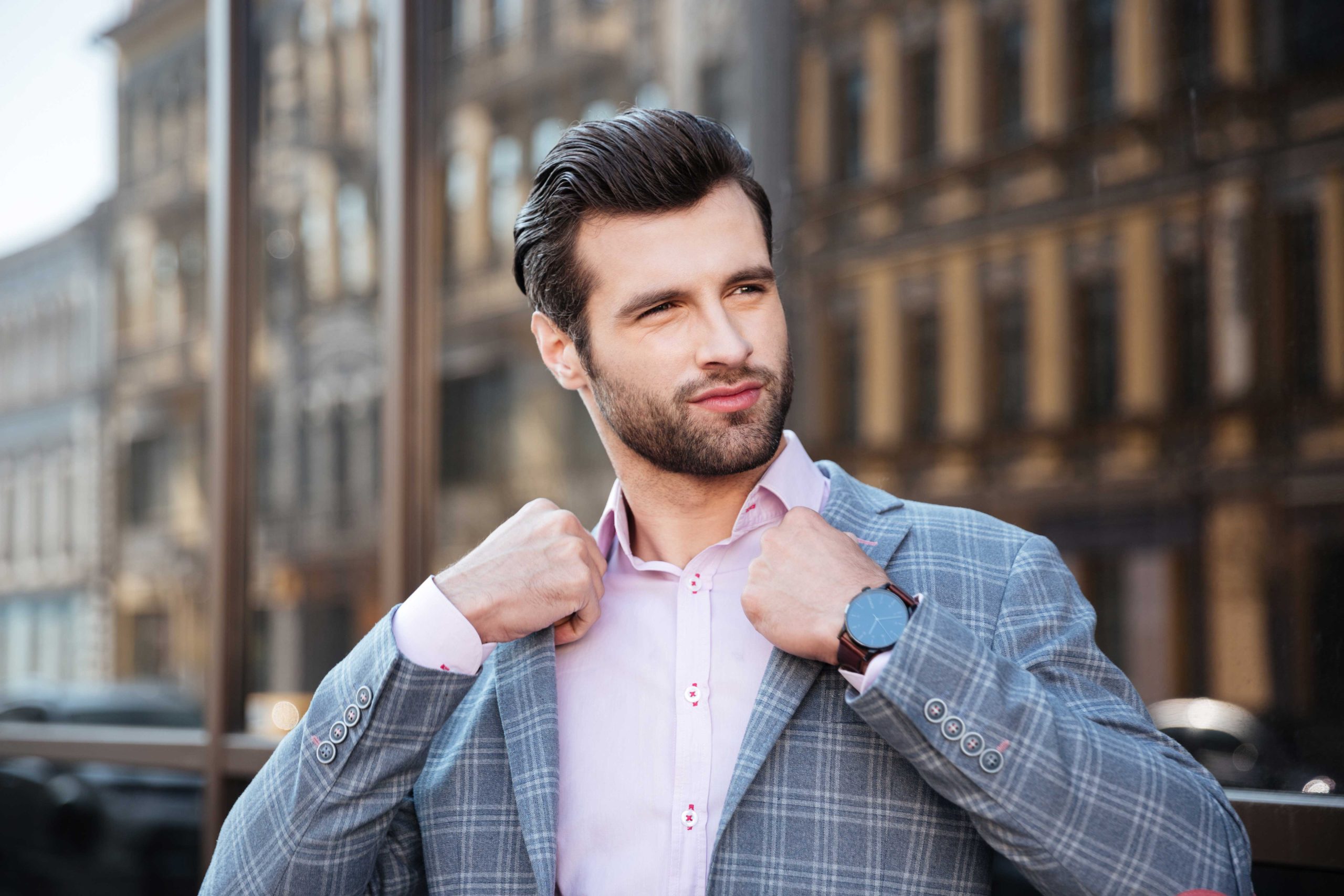 portrait-attractive-young-man-straightening-his-jacket